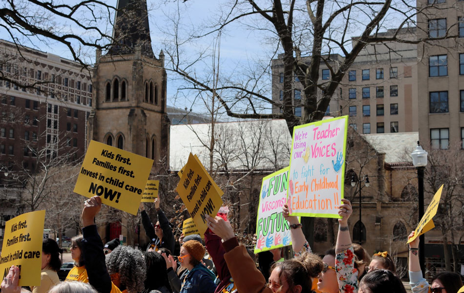 Community members held signs to highlight the issue of early childhood education