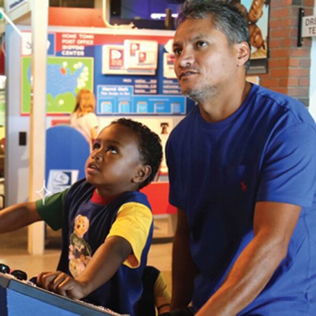 Father and son use interact with exhibit at Betty Brinn